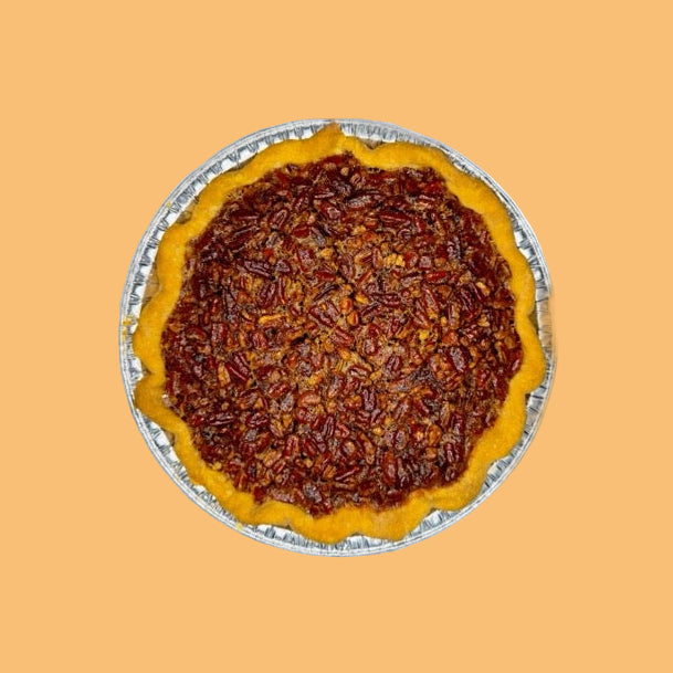 a pecan pie on an orange background