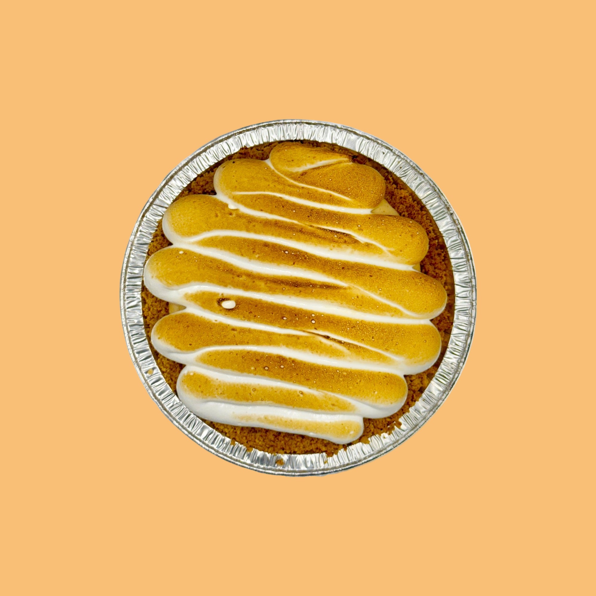 Pumpkin pie with a toasted meringue top on an orange background